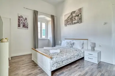 a white bedroom with a bed and a dresser at Bright, Romantic & Super Stylish Old Town Flat with Seaview & Shared Terrace in Kotor