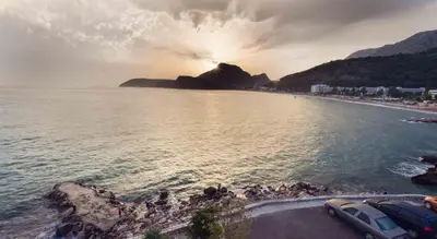 a beach with a group of people on the water at Love Live Hotel in Sutomore