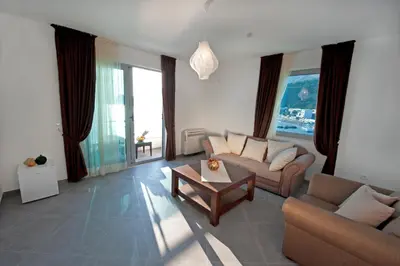 a living room with a couch and a table at Love Live Hotel in Sutomore