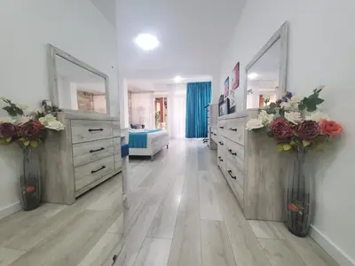 a large bathroom with two dressers and two mirrors at Egon Apartments in Budva