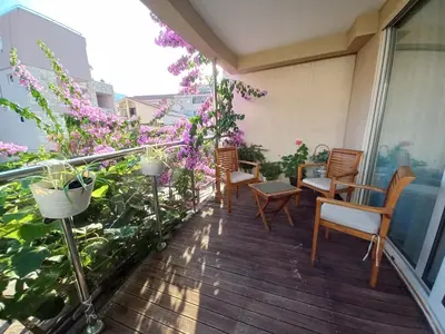 a balcony with chairs and flowers on a building at Egon Apartments in Budva