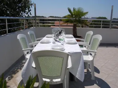 a white table and chairs on a patio at Villa Elkom, App 16 in Ulcinj