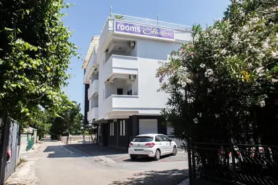 a white car parked in front of a building at Villa Elkom, App 16 in Ulcinj
