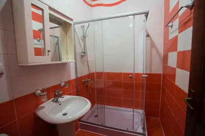 a bathroom with a sink and a glass shower at Villa Elkom, App.17 in Ulcinj