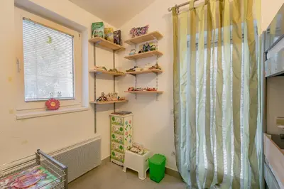 a childs room with shelves and a window at Olive Garden Apartment in Petrovac na Moru