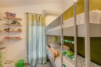 a childs bedroom with a bunk bed at Olive Garden Apartment in Petrovac na Moru