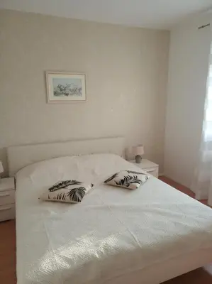 a bedroom with a bed with two pillows on it at Apartman Bojana in Bar