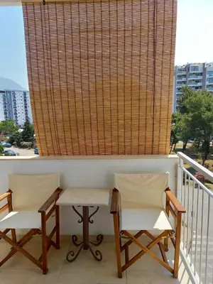 two chairs and a table on a balcony at Apartman Bojana in Bar