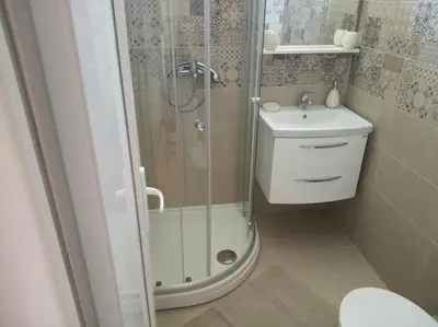 a bathroom with a shower and a toilet and a sink at Apartman Bojana in Bar
