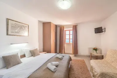 a bedroom with a large bed with towels on it at R club Apartments Old Town Budva in Budva