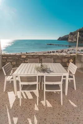 a white table and chairs on the beach at R club Apartments Old Town Budva in Budva