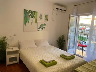 a bedroom with a bed with two towels on it at Mint Apartment studio in Petrovac na Moru
