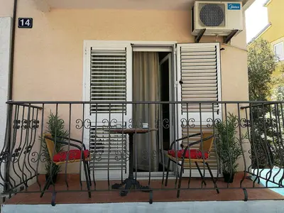 a balcony with a table and chairs on a building at Mint Apartment studio in Petrovac na Moru