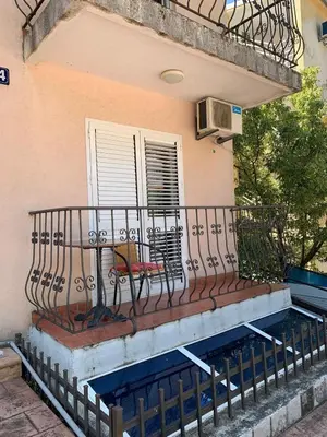 a balcony with a bench on a building at Mint Apartment studio in Petrovac na Moru