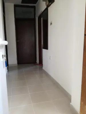 an empty hallway with a door and a tile floor at Forest house in Sutomore