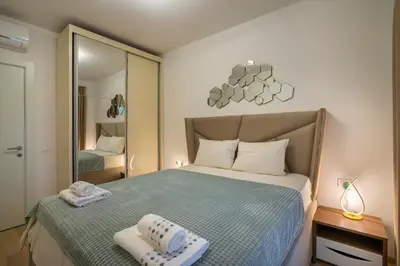 a bedroom with a bed with two towels on it at Montesun Boka Apartments in Budva