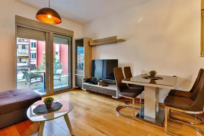 a living room with a couch and a table at Montesun Boka Apartments in Budva