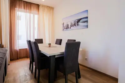 a dining room with a table and chairs at Montesun Boka Apartments in Budva