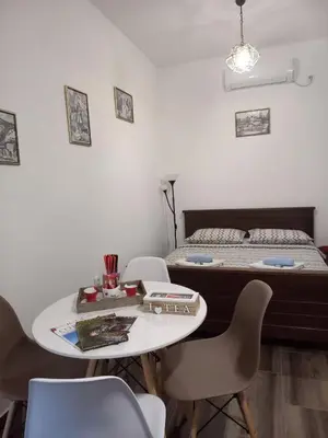 a room with a bed and a table and chairs at Aleksa in Cetinje