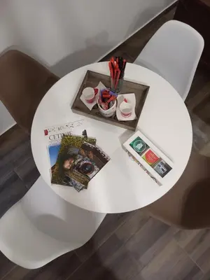 a white table with a tray of pens and a magazine at Aleksa in Cetinje