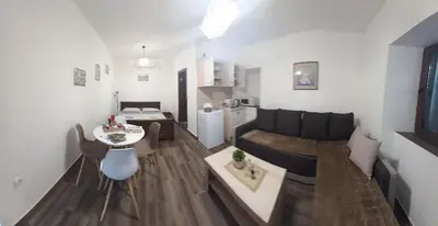 a living room with a couch and a table at Aleksa in Cetinje