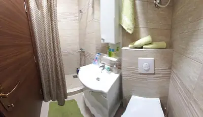 a bathroom with a white toilet and a sink at Aleksa in Cetinje