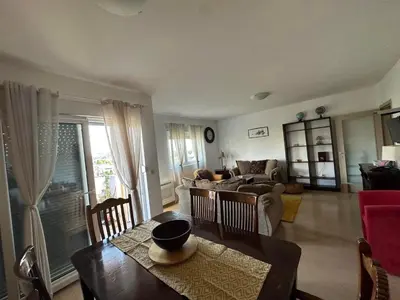 a living room with a table and a couch at City Apartment in Podgorica