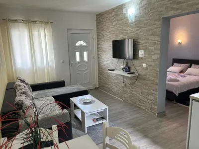 a small living room with a bed and a couch at Green Field Apartments in Virpazar