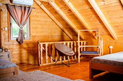 a bedroom with a bed and a chair in a attic at Green Field Apartments in Virpazar