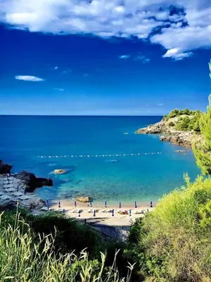 a group of people on a beach near the water at Villa Jovanovic Sutomore in Sutomore
