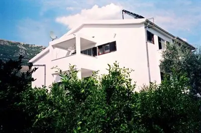 a white building with trees in front of it at Villa Jovanovic Sutomore in Sutomore
