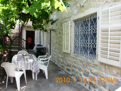 a table and chairs sitting outside of a building at Vicky Apartments in Kotor