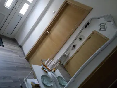 a hallway with a wooden door and a staircase at Vicky Apartments in Kotor