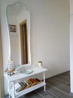 a bathroom with a white vanity with a large mirror at Vicky Apartments in Kotor