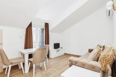 a living room with a couch and a table at Apartments Rozer in Kotor