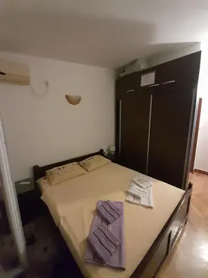 a bedroom with a bed with two towels on it at Apartments Kovačević in Petrovac na Moru