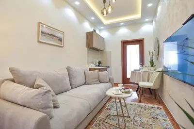 a living room with a couch and a table at Beach House in Petrovac na Moru