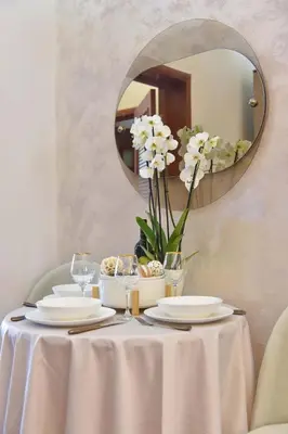 a table with a white table cloth and a mirror at Beach House in Petrovac na Moru