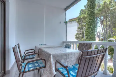 a porch with a table and chairs on a balcony at Apartments Đurašević Ivo in Sveti Stefan