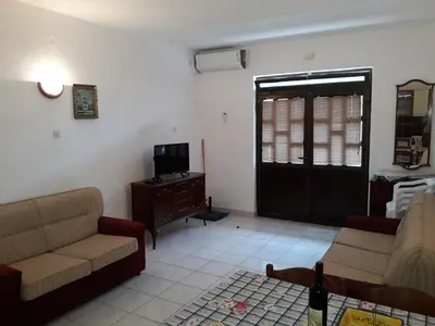 a living room with two couches and a television at Apartments Đurašević Ivo in Sveti Stefan