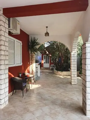 a patio with an archway and a table and chairs at Apartments Boreta II in Budva