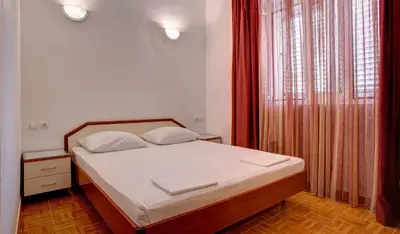 a bedroom with a bed and a window at Apartments Boreta II in Budva