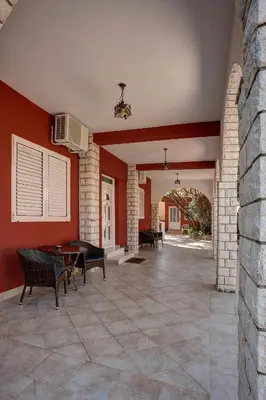 a living room with red walls and a pool table at Apartments Boreta II in Budva