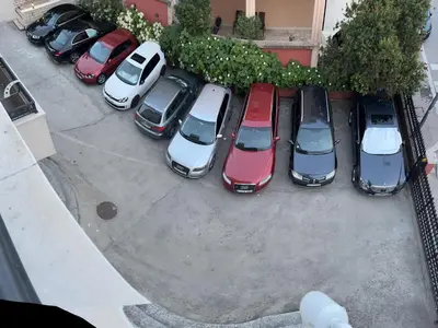 an aerial view of cars parked in a parking lot at Apartments Boreta II in Budva