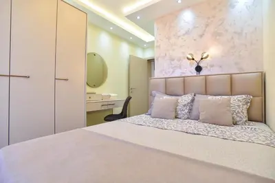 a bedroom with a large bed and a desk at Vila Apartments Lidija in Petrovac na Moru