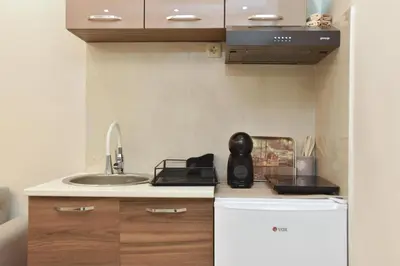 a small kitchen with a sink and a counter top at Vila Apartments Lidija in Petrovac na Moru