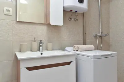 a bathroom with a white sink and a toilet at Vila Apartments Lidija in Petrovac na Moru