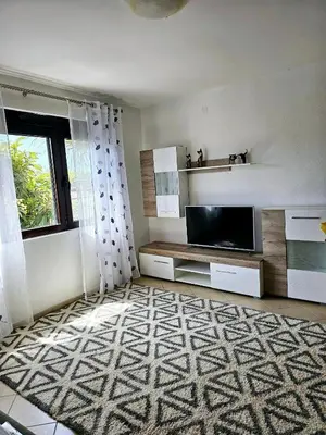 a living room with a flat screen tv and a window at Villa Vi apartmen in a villa with a swimming pool in Bar