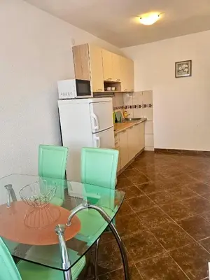 a kitchen with a glass table and a white refrigerator at Villa Vi apartmen in a villa with a swimming pool in Bar