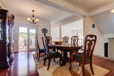 a dining room with a wooden table and chairs at Vera Apartments in Ulcinj